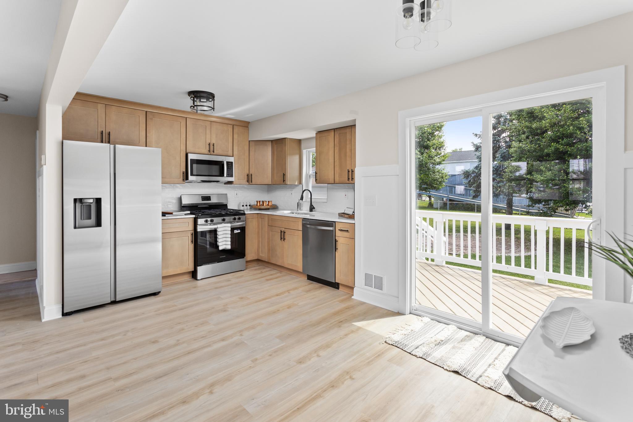124 Gary Drive Hamilton, NJ 08690 - Photo 9 of 31 a kitchen with stainless steel appliances granite countertop a refrigerator a stove a sink dishwasher a microwave oven with cabinets and wooden floor