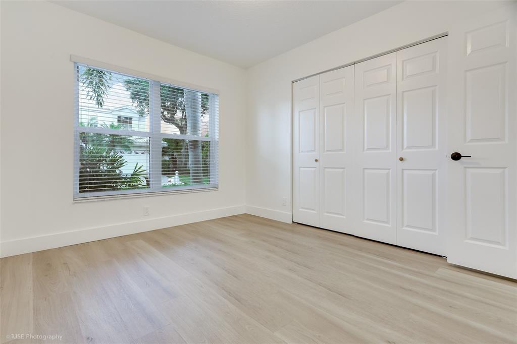 17282 Ventana Drive Boca Raton, FL 33487 - Photo 16 of 23 a view of an empty room with wooden floor and a window
