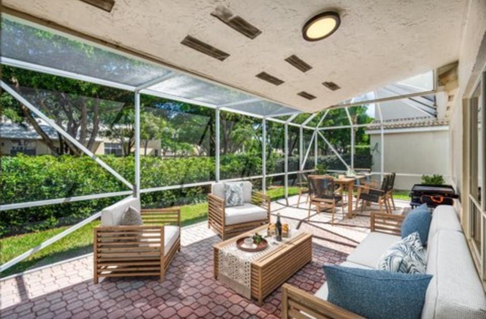 17282 Ventana Drive Boca Raton, FL 33487 - Photo 19 of 23 a view of a patio with couches chairs and a wooden floor