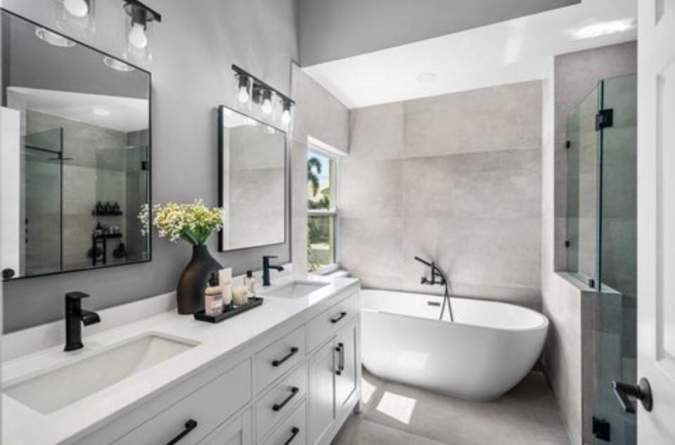 17282 Ventana Drive Boca Raton, FL 33487 - Photo 4 of 23 a bathroom with double vanity sinks a large mirror and a shower