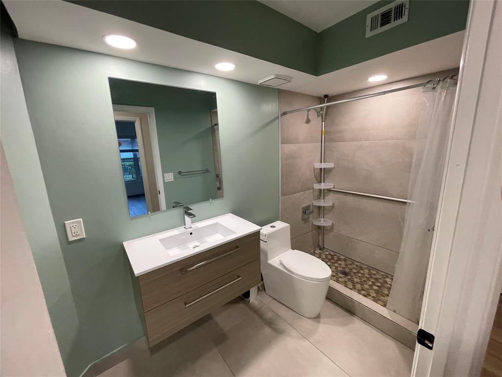17282 Ventana Drive Boca Raton, FL 33487 - Photo 5 of 23 a bathroom with a sink toilet and shower