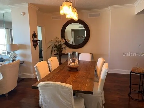 a dining room with furniture and a mirror