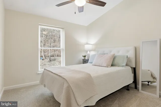 a bedroom with a bed and a lamp