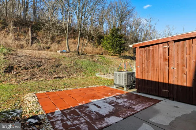 a backyard of a house with barbeque oven table and chairs