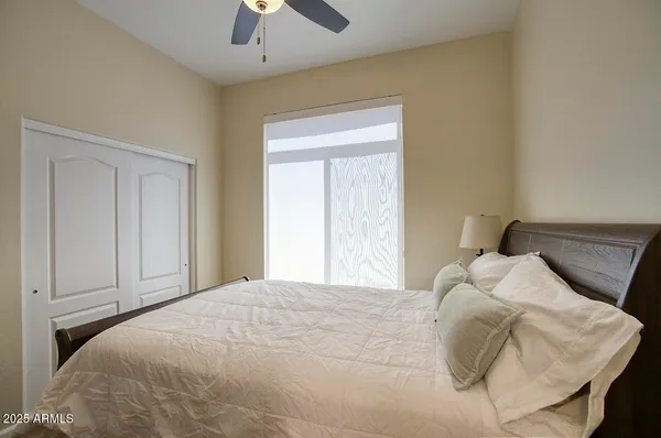 a bedroom with furniture and a flat screen tv