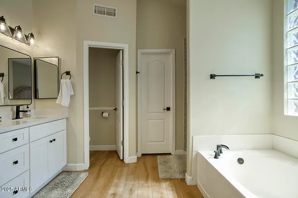 a living room with furniture a flat screen tv and a window