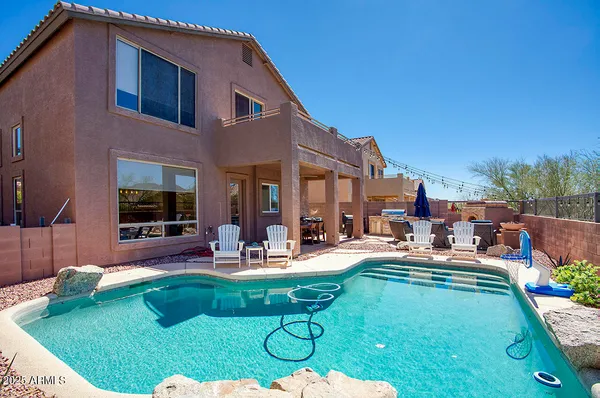 a view of a backyard with sitting area