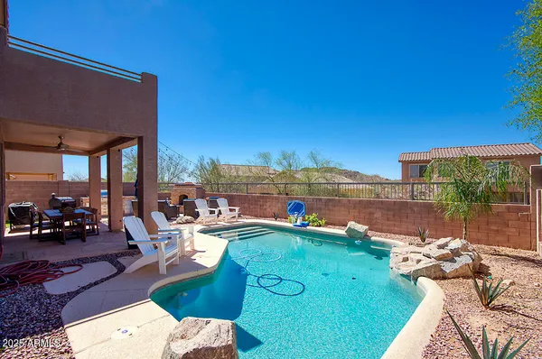 a living room with furniture a fireplace and a floor to ceiling window