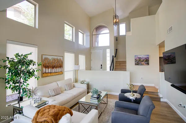 a living room with furniture a large window and a flat screen tv