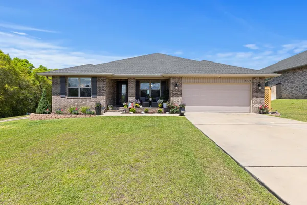 a front view of house with yard and outdoor seating