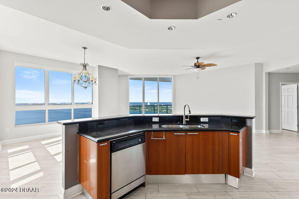241 Riverside Drive, Unit 2610 Daytona Beach, FL 32117 - Photo 11 of 31 a kitchen with a sink and a refrigerator