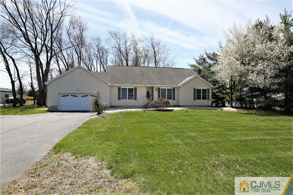 543 Georges Road Dayton, NJ 08810 - Photo 2 of 23 a front view of a house with a garden and yard