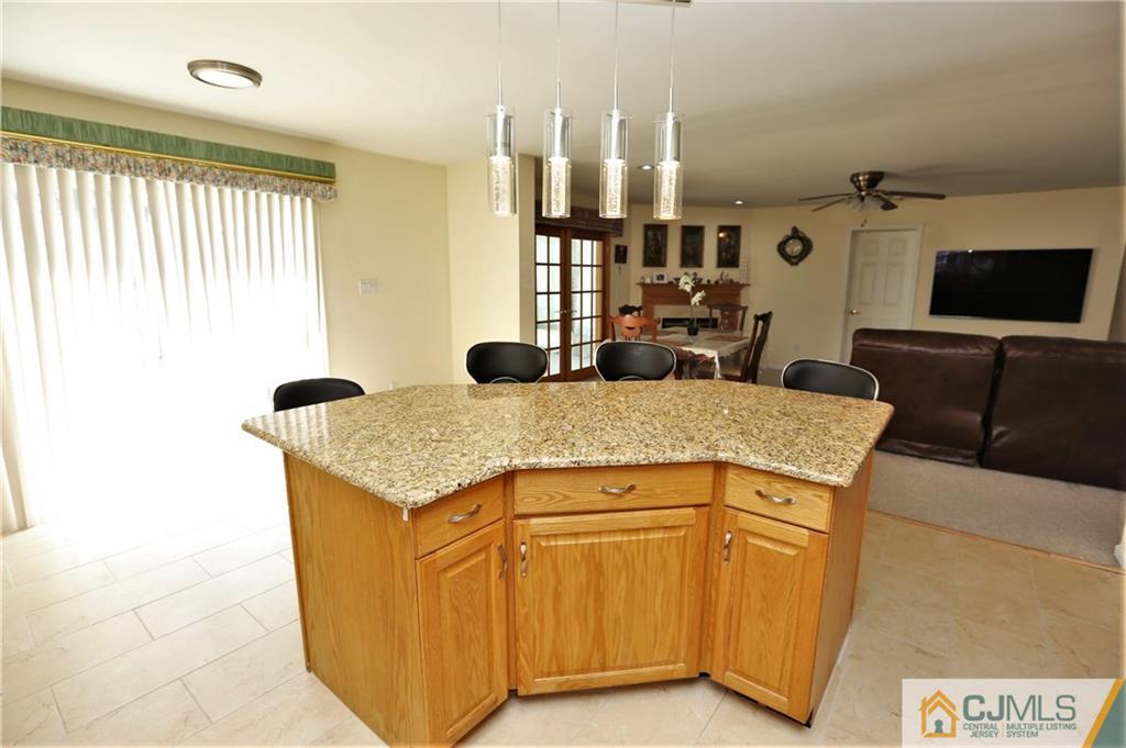 543 Georges Road Dayton, NJ 08810 - Photo 12 of 23 a kitchen with stainless steel appliances granite countertop a sink and cabinets