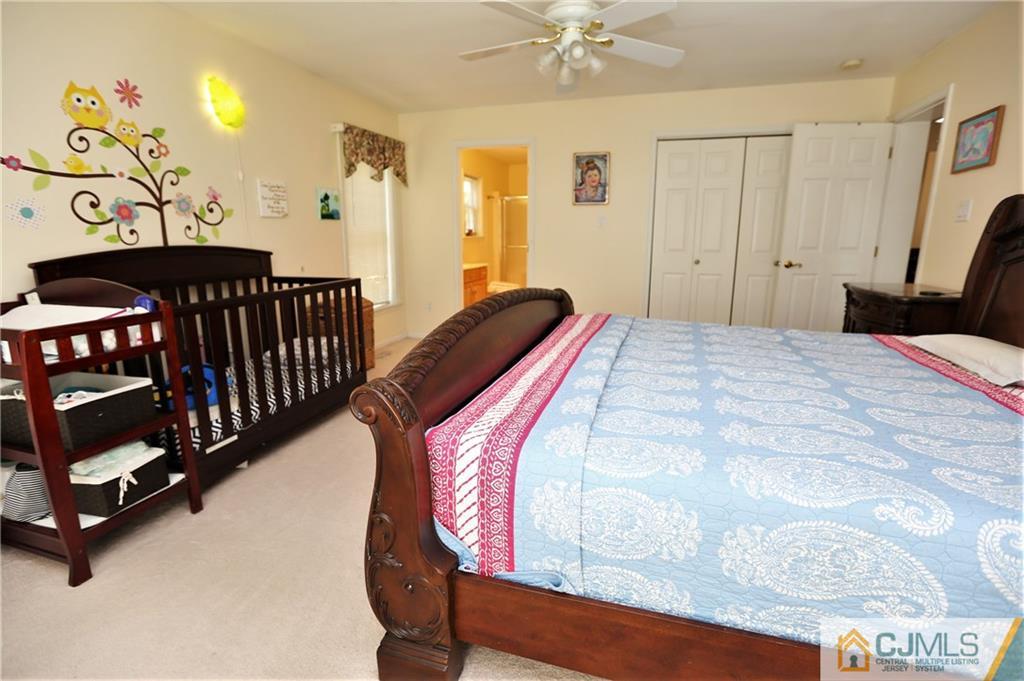 543 Georges Road Dayton, NJ 08810 - Photo 13 of 23 a bedroom with a bed and a mirror