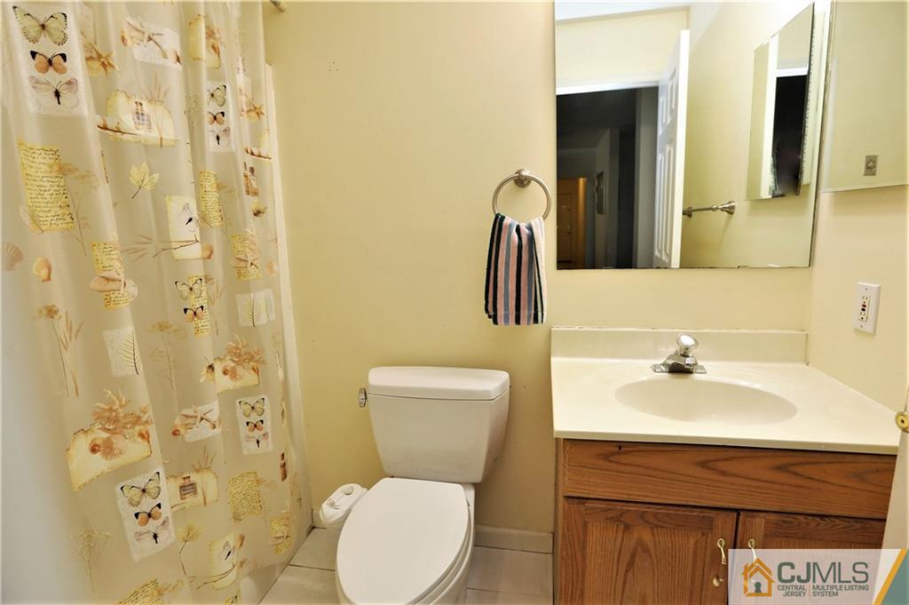 543 Georges Road Dayton, NJ 08810 - Photo 18 of 23 a bathroom with a sink a toilet and shower curtain