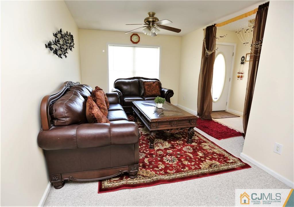 543 Georges Road Dayton, NJ 08810 - Photo 3 of 23 a living room with furniture and a rug