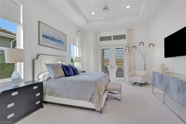 a bedroom with a bed and flat screen tv