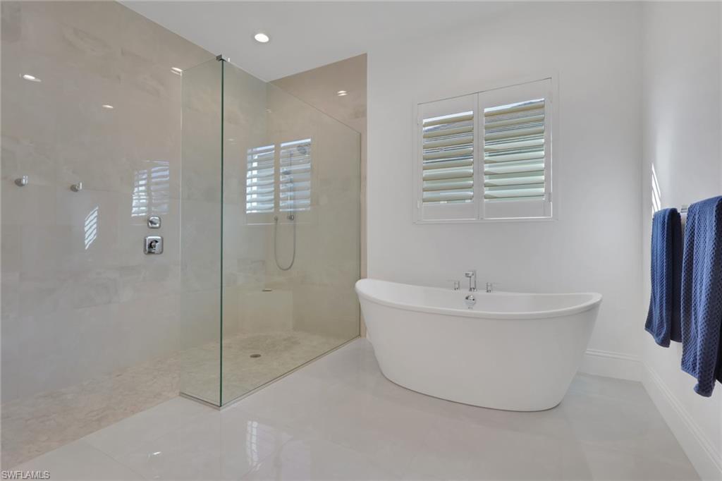 19114 WildBlue Boulevard Fort Myers, FL 33913 - Photo 17 of 50 a bathroom with a bathtub and shower