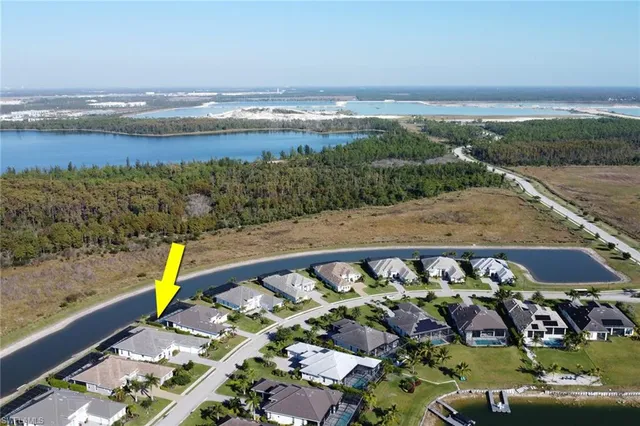 a aerial view of a house with a big yard and potted plants