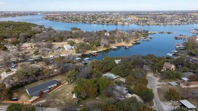 an aerial view of a houses with a lake