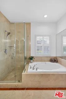 a bathroom with a tub shower and sink