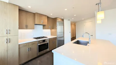 a kitchen with a stove a sink and a refrigerator