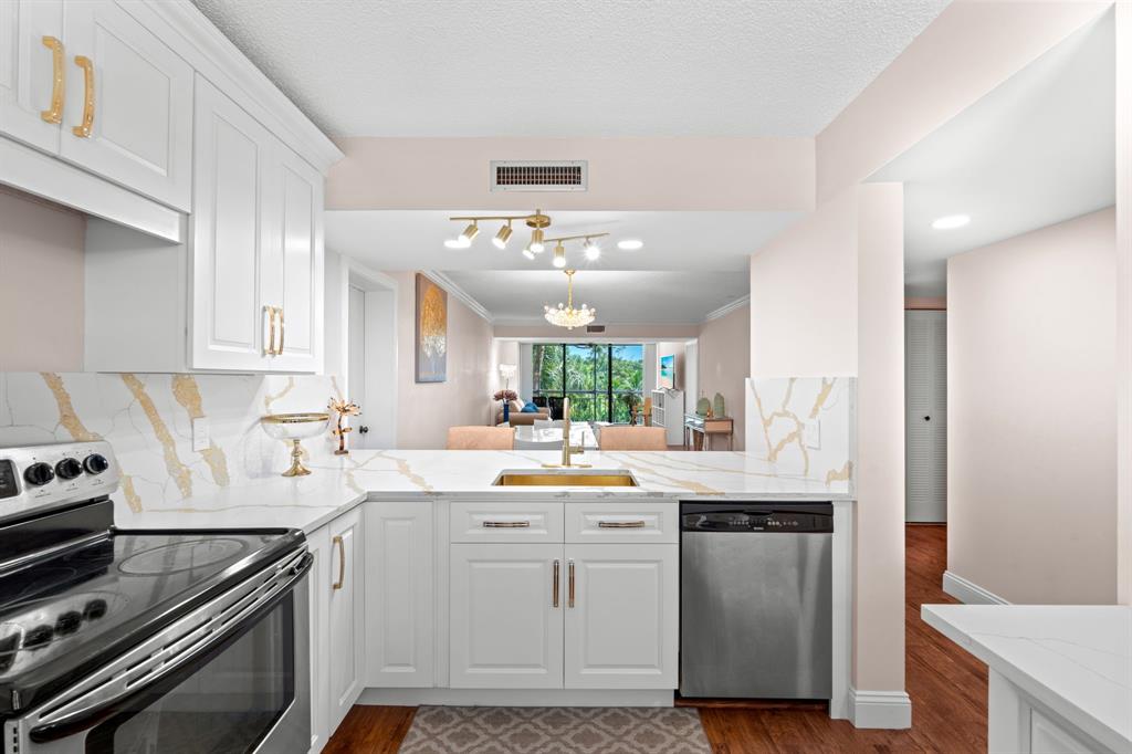 a kitchen with a sink stove and cabinets