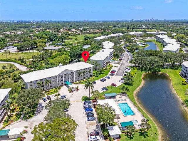 an aerial view of residential houses with outdoor space and river