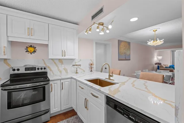 a kitchen with a sink a stove and cabinets