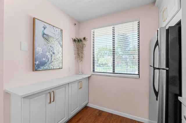 a view of kitchen with window and refrigerator