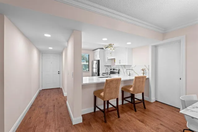 a view of a dining room with furniture and wooden floor