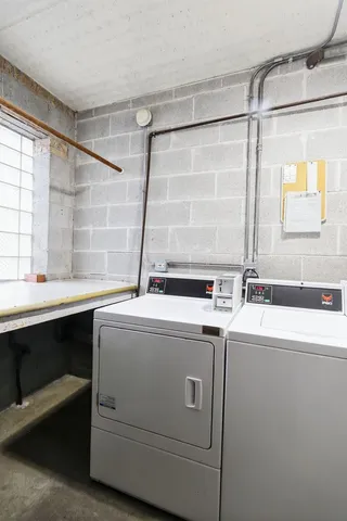 a view of a sink and dishwasher with washer dryer