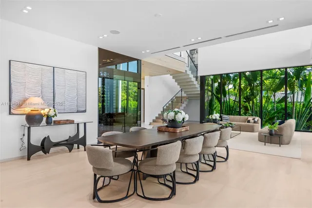 a living room with furniture and large windows