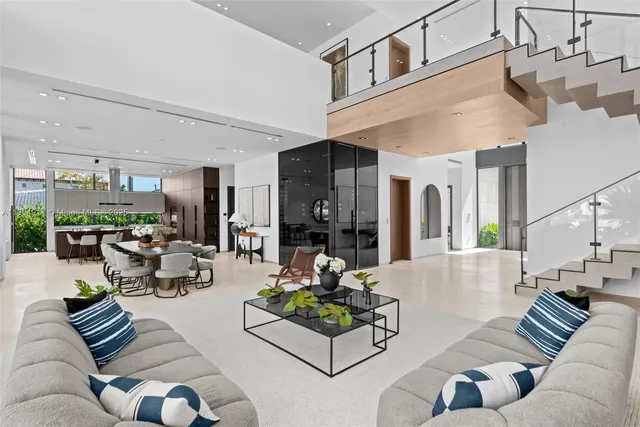 a living room with furniture and large windows