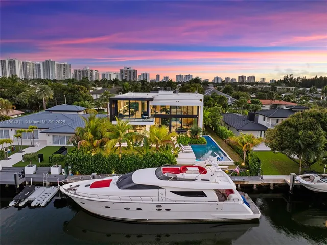 a front view of a house with a garden and yard