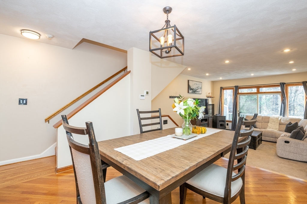 905 Sherwood Forest Lane, Unit 905 Saugus, MA 01906 - Photo 14 of 42 a dining room with furniture a chandelier and wooden floor