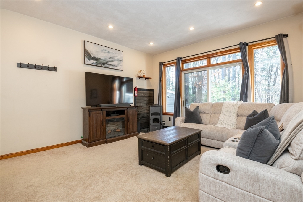 905 Sherwood Forest Lane, Unit 905 Saugus, MA 01906 - Photo 16 of 42 a living room with furniture and a flat screen tv