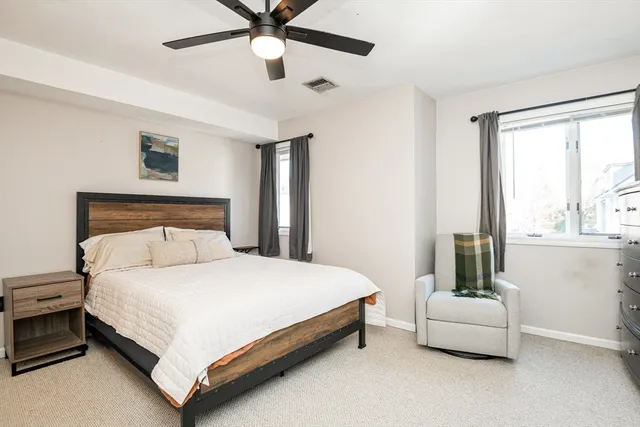 a bedroom with a bed and a couch