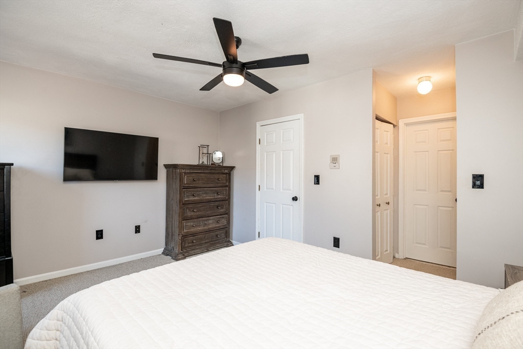 905 Sherwood Forest Lane, Unit 905 Saugus, MA 01906 - Photo 26 of 42 a bedroom with a bed and a flat screen tv