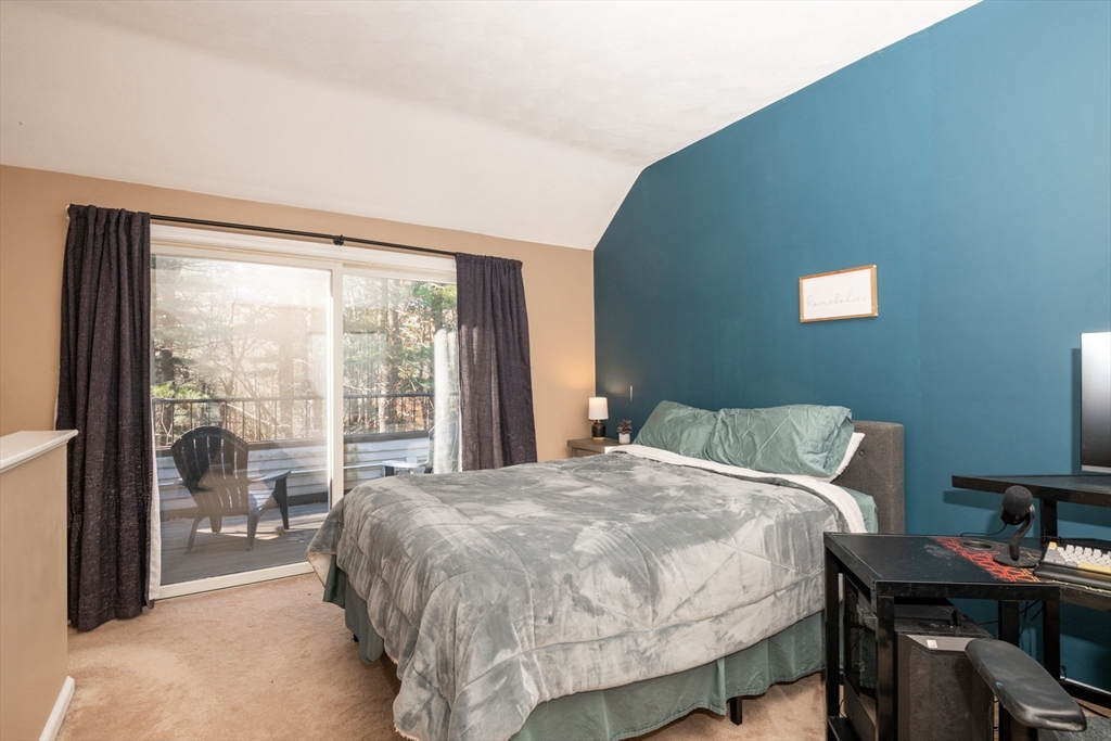 905 Sherwood Forest Lane, Unit 905 Saugus, MA 01906 - Photo 32 of 42 a bed sitting in a bedroom next to a window