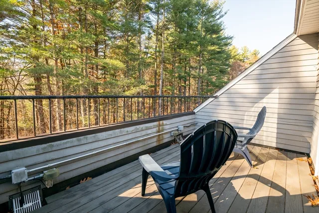 a view of balcony with wooden floor and outdoor seating