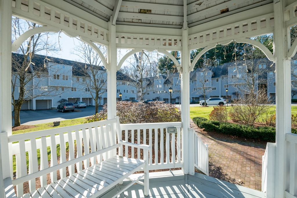 905 Sherwood Forest Lane, Unit 905 Saugus, MA 01906 - Photo 39 of 42 a view of a porch with a floor to ceiling window and wooden floor