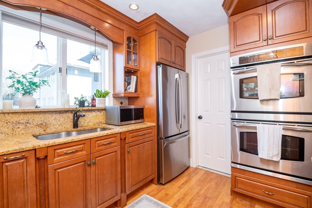 905 Sherwood Forest Lane, Unit 905 Saugus, MA 01906 - Photo 10 of 42 a kitchen with stainless steel appliances granite countertop a refrigerator and a sink