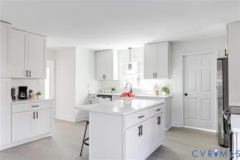 a kitchen with a sink cabinets and appliances