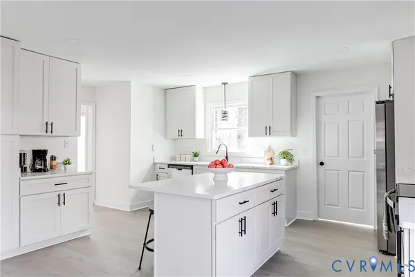a kitchen with a sink cabinets and appliances