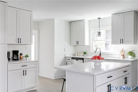 a kitchen with white cabinets sink and white appliances