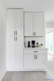 a kitchen with white cabinets and white appliances