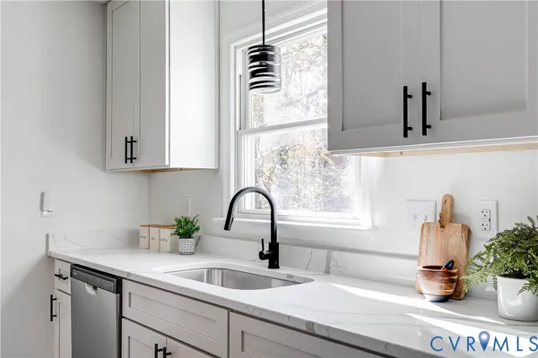 a kitchen with a sink and potted plant