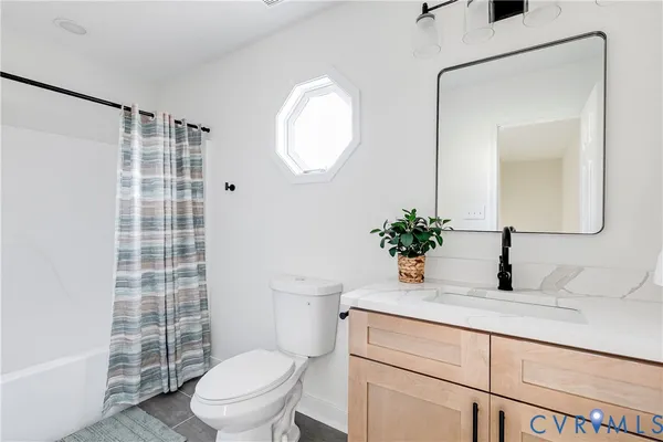 a bathroom with a sink a toilet a mirror and shower