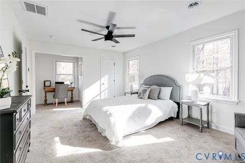 a bed room with a bed and a chair